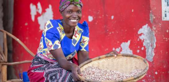 Janet Ben, 31, proudly showing the beans that she sells at the market