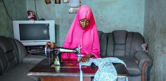 A girl using her sewing machine 