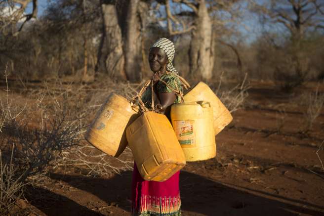 Rose Jonathan carrying jerry cans