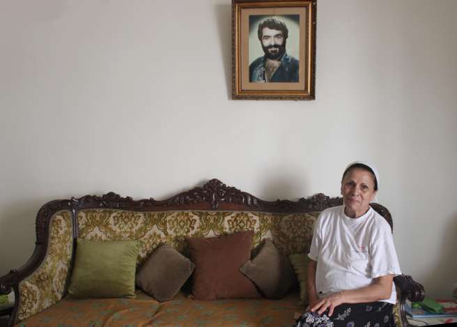 Vera Nakkour sits beneath a picture of her late husband Eliyas Yaghliyan who she lost during the Civil War