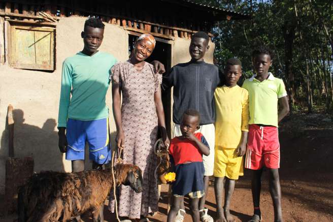 Banchi Aseffa with her four sons and a sheep that she has purchased from her profits. 