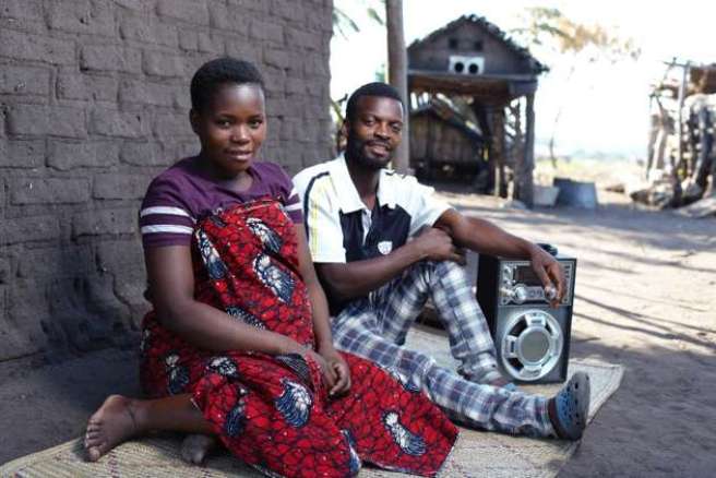 Brian and Flora Kagoma sat beside a wall