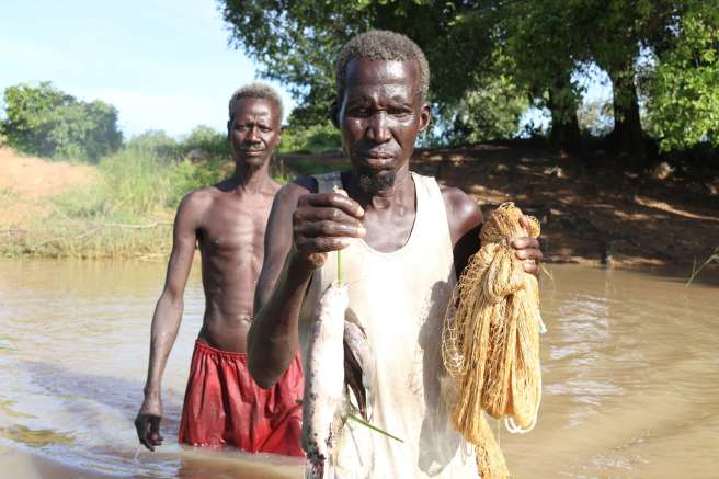 Mayar Chok Madut and Simon Aqui Akot, Fishermen showing their catch from Nyinabyei River, South Sudan 