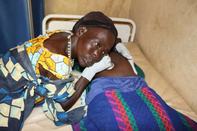 Abuog Buolla Ateny attends to a mother at Mbili Primary Health Care Unit South Sudan