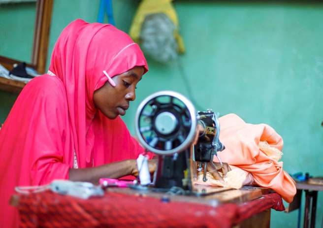 Zuwaira at her sewing machine