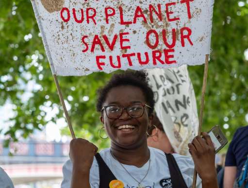 A young person protests against climate change in London. 