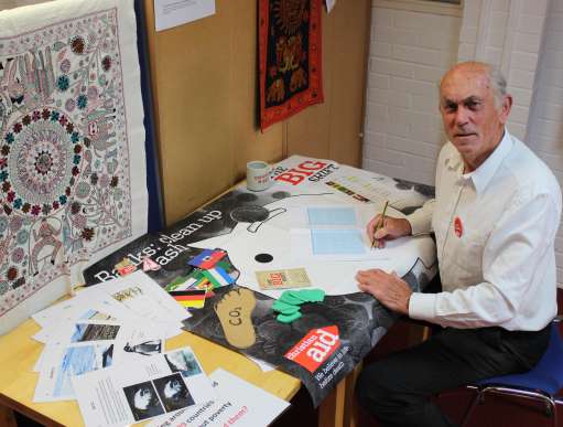 John Griffith, a volunteer teacher sits at a desk