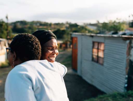 Two activists embrace in KwaMashu, an informal settlement north of Durban, South Africa. Christian Aid’s partner, Church Land Programme, works closely with the shackdweller movement (Abahlali baseMjondolo) so that people in KwaMashu can live without fear.