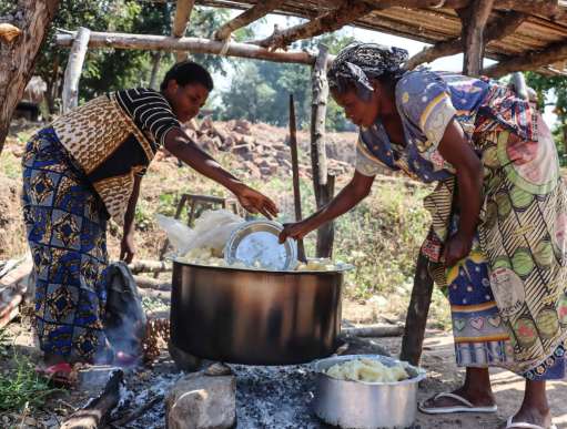 Naba cooks cassava for 20 people taking refuge in her home, in the DRC