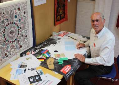 John Griffith, a volunteer teacher sits at a desk