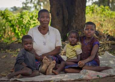 Elizabeth Iornenge with her three grandchildren outside their home in Benue State, Nigeria.