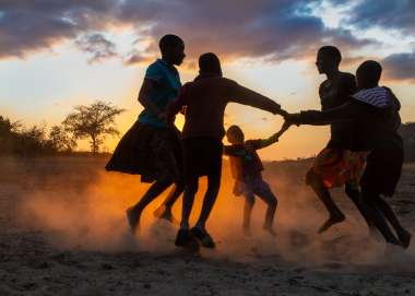 Vimbainashe and Phanuel are playing a game with their friends just outside their home in Chadanyika village