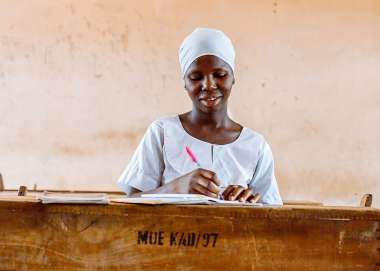 A women writing into her notebook