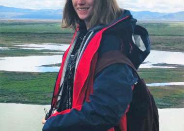 Freya smiling at the camera near a marsh