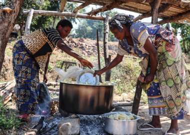 Naba cooks cassava for 20 people taking refuge in her home, in the DRC