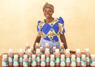 Janet standing behind her bottles of coffee