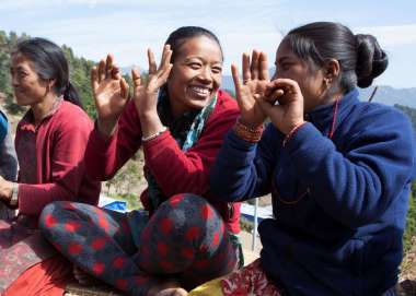 Smiling women sitting together