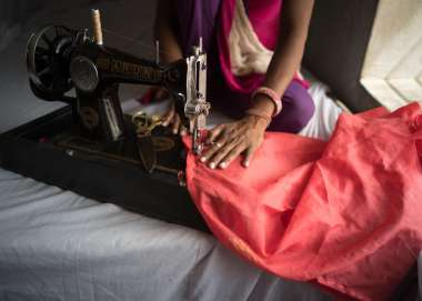 Close up of person using a sewing machine