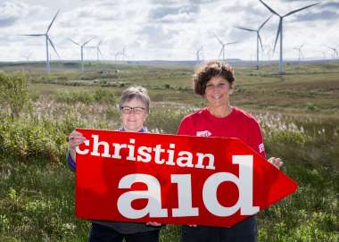 Two women holding a christian aid banner