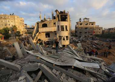 People in Gaza explore the rubble after bombings 