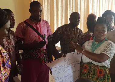 A community representatives shows the needs of her community in a meeting with duty bearers