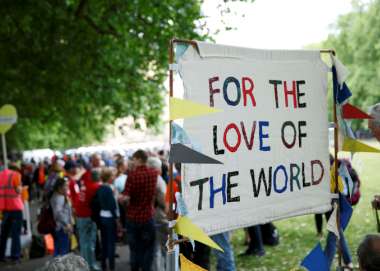 A sign saying the words "For the love of the world"